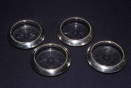 Set of four sterling silver glass coasters