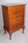 Early 20th Century mahogany six drawer music cabinet on cabriole legs, 86.