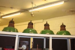 Set of four green industrial light fittings