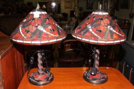 Pair of Tiffany style lamps decorated with dragonflies on red background,