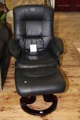 Black leather adjustable swivel armchair and footstool
