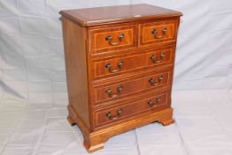Neat mahogany and satinwood banded chest of two short above three long drawers on bracket feet, 73.