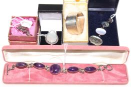 Four pieces of silver mounted jewellery and silver napkin ring