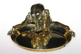 A Victorian polished brass inkwell, cast as a setter lapping from a bowl,