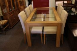 Rectangular oak and inset glazed top dining table and six faux leather dining chairs