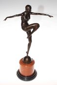 Bronze lady in a dancing pose on a marble plinth,