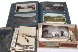 Postcard album and two boxes, depicting photographer D.