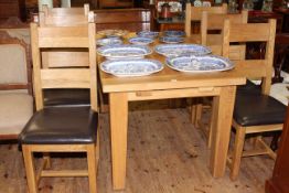 Medium oak extending dining table with integral leaf together with six bar back dining chairs