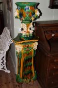 Majolica style jardiniere on stand decorated with lions and figures,