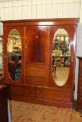 Edwardian mahogany and line inlaid combination wardrobe having central door above two drawers
