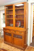 Victorian oak cabinet bookcase having two glazed panel doors above two drawers with two carved