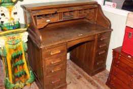 Early 20th Century oak S-shaped double pedestal roll top desk,