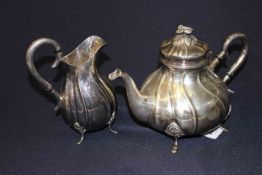 Continental silver teapot and milk jug, of baluster wrythen shape,