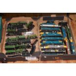 Two boxes of model railway diesel loco's and steam trains and tenders.