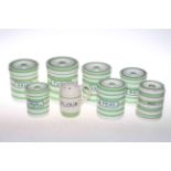 Collection of seven green and white kitchen storage jars and a flour caster (8).