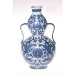 A Chinese blue and white two handled double gourd vase decorated with dragons,