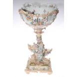 Continental floral encrusted centre piece with maiden and cherub, 51cm.