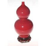 Chinese double gourd sang de boeuf vase with wood stand, Qianlong mark 24cm.