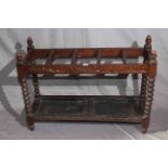 Carved oak bobbin leg five division stick stand, 68cm by 92cm.