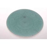 Chinese Celadon circular dish with peony design and manufacture mark.