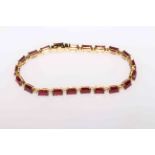 18 carat Yellow Gold Ruby and Diamond bracelet featuring, 21 emerald cut Rubies (13.