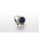 14 carat White Gold Sapphire and Diamond ring featuring centre, oval cut very dark blue Sapphire (3.