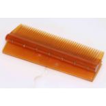 Amber colour hair comb set with seven cabochon gems (ruby or amethyst), 10cm.