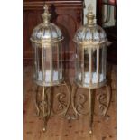 Pair of brass lanterns in stands, 110cm.