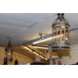 Pair of ornate metal and glass cylindrical hall lanterns.