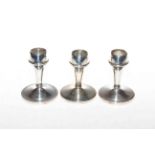 Three silver candle holders, Birmingham 1931 and 1933.