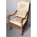 Carved oak arched back tapestry open armchair, 115cm by 66cm.