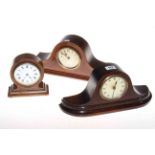 Three small wooden mantel clocks.