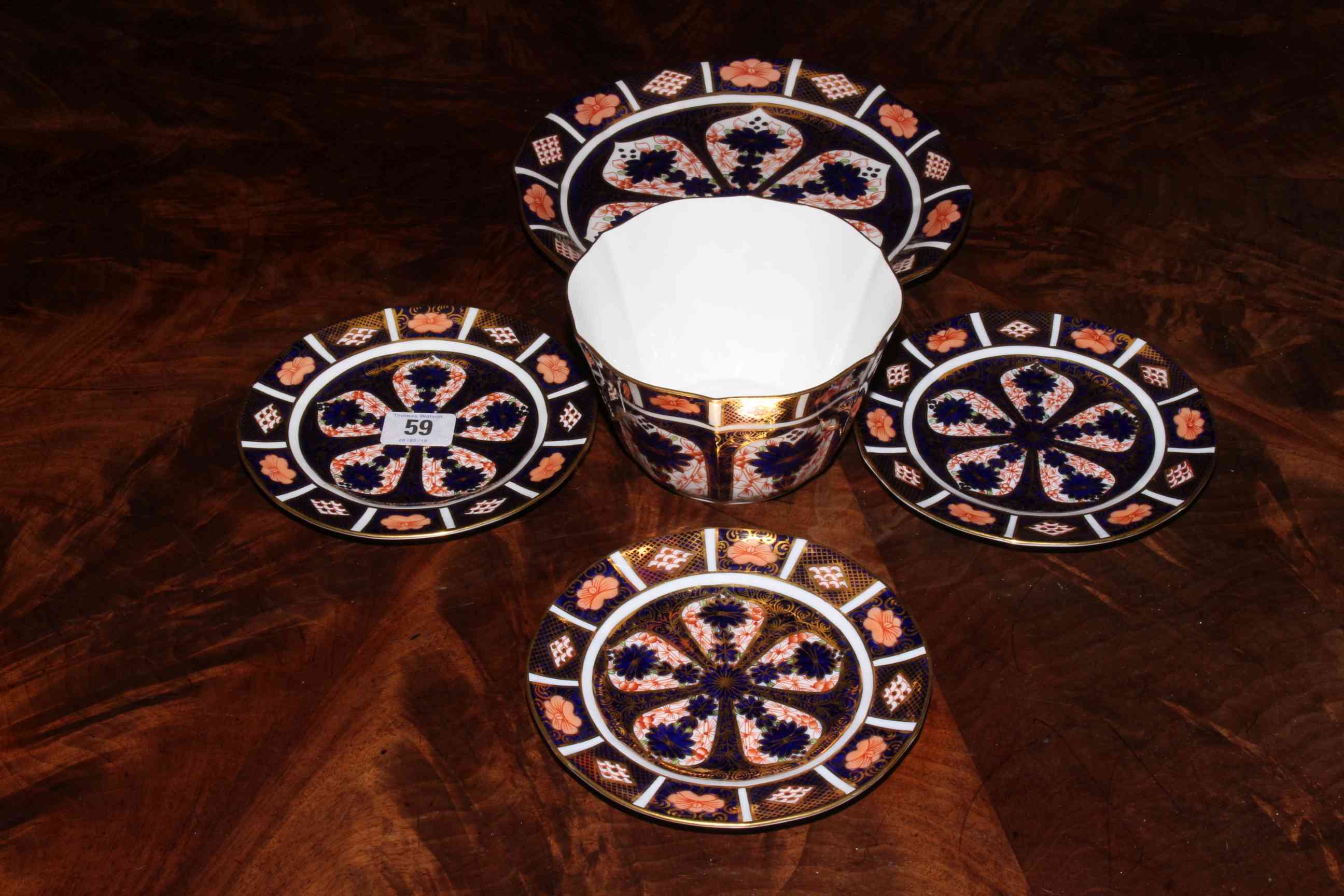 Four Royal Crown Derby plates and sugar bowl.