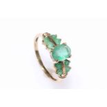 9 carat gold emerald ring, set with nine emeralds, size O½.