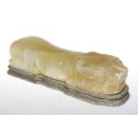 Onyx carving of a recumbent lion on plinth, 24cm long.