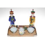 Three Oriental figures, two tea bowls and small mug.