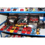 Large collection of boxed and unboxed Burago and Maisto model vehicles.