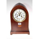 Edwardian inlaid mahogany arch top mantel clock with enamel and brass dial and visible escapement.