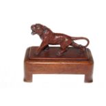 Cast tiger on wooden plinth, 17cm by 10cm.