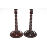 Pair of mahogany bobbin candlesticks, 31cm.