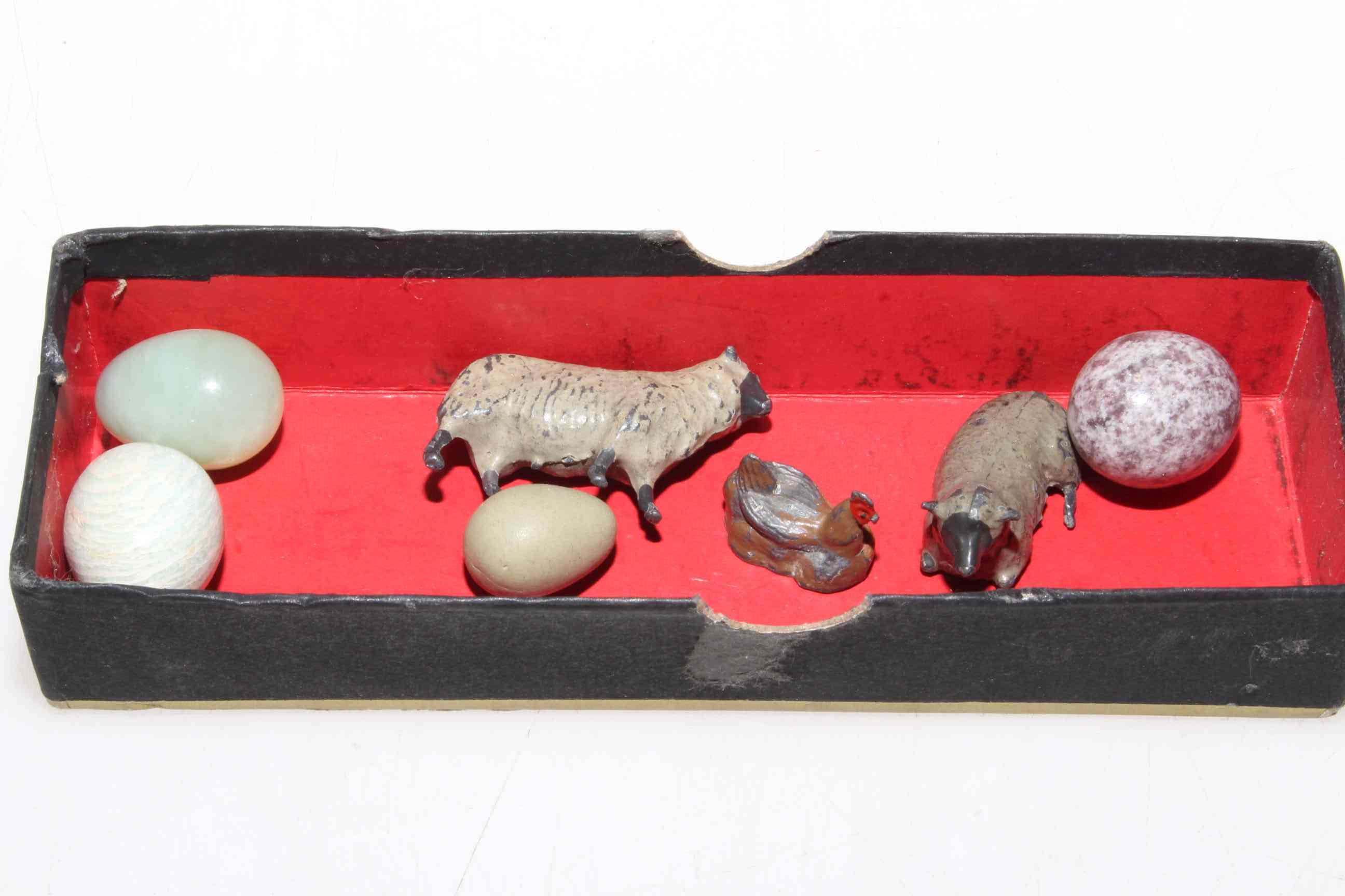 Four miniature eggs and three lead animals (7).
