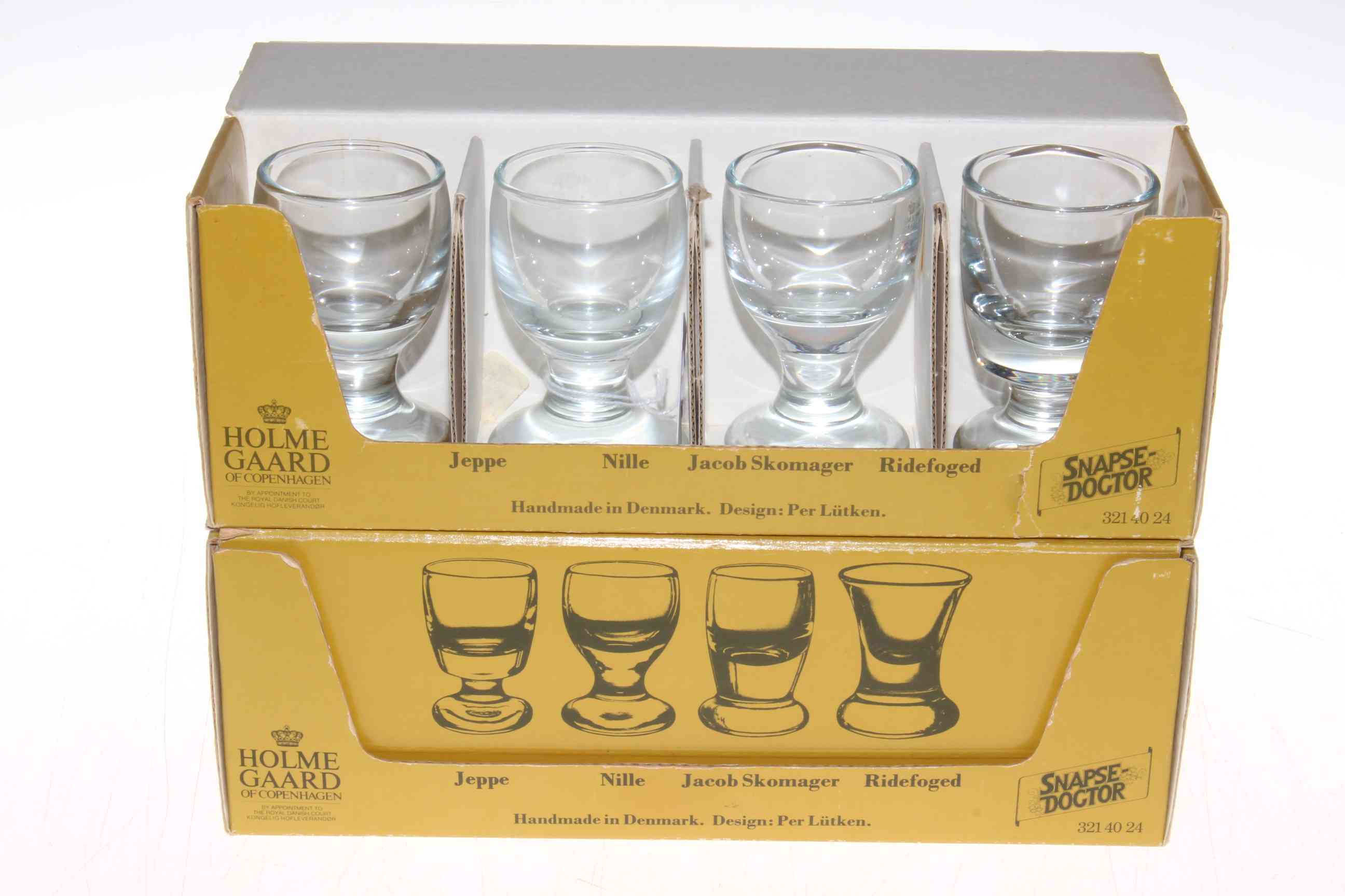 Two boxes of Holmegaard glasses.