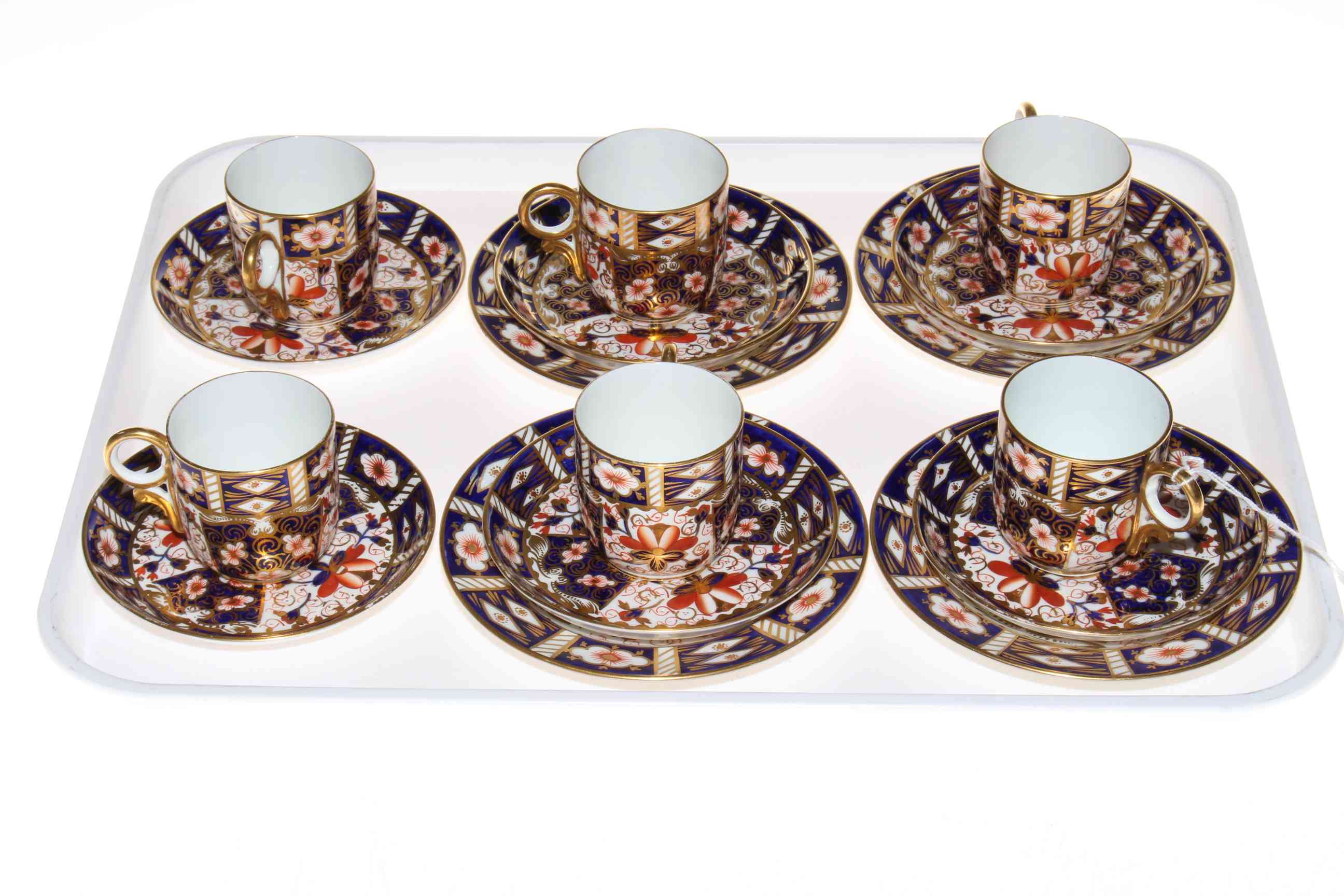 Set of six Royal Crown Derby coffee cups and saucers with four plates.