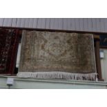 Eastern rug with a beige ground, 1.75 by 1.20.