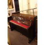 Yamaha lacquered rosewood upright overstrung piano, serial number D3357201.