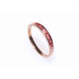 Eleven ruby channel set ring, 9 carat gold, size Z.