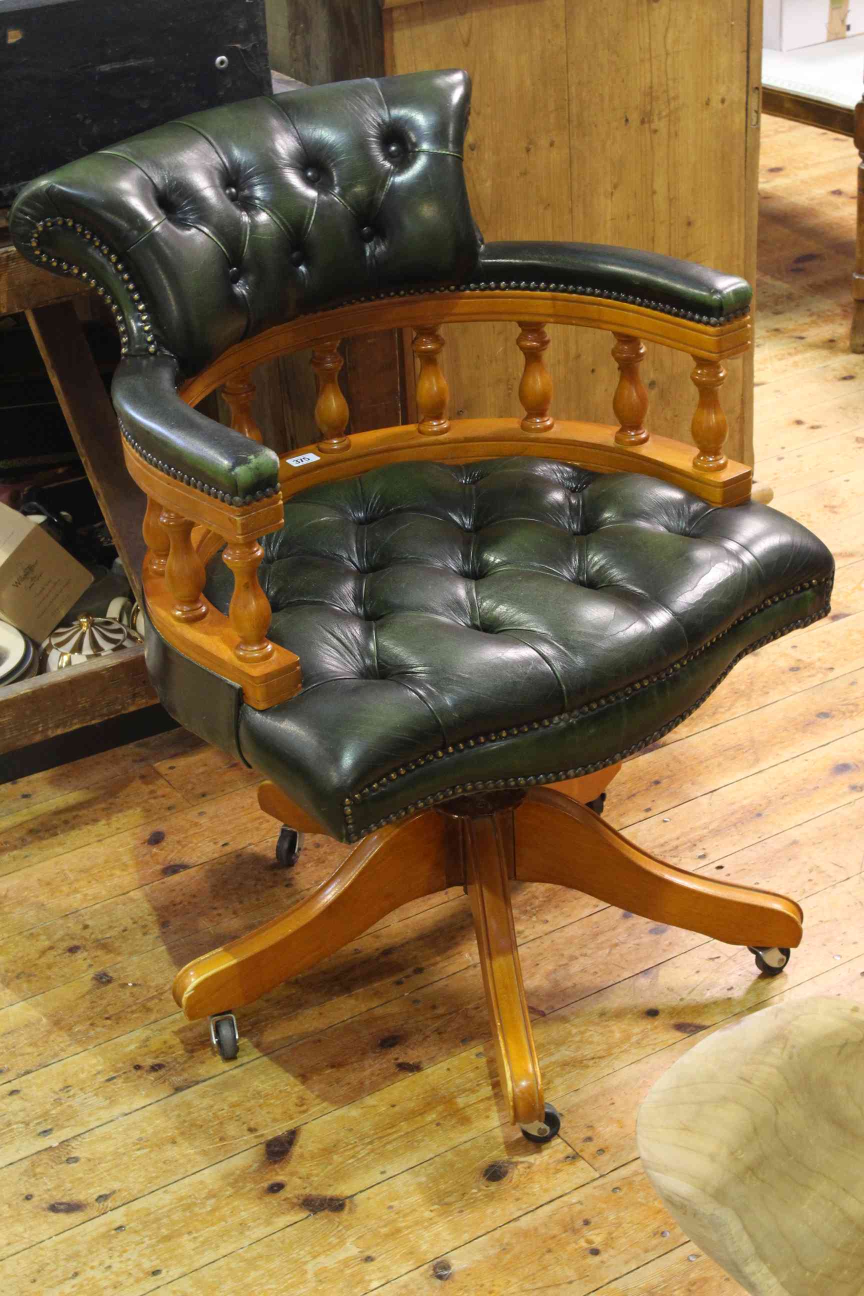 Green buttoned leather captains style swivel desk chair.