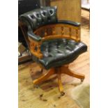 Green buttoned leather captains style swivel desk chair.