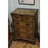 Neat burr walnut and walnut five drawer chest on bracket feet, 76cm by 55cm.