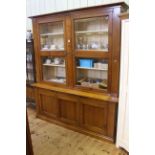 Continental style cabinet bookcase having two glazed doors above a slide with three doors below,